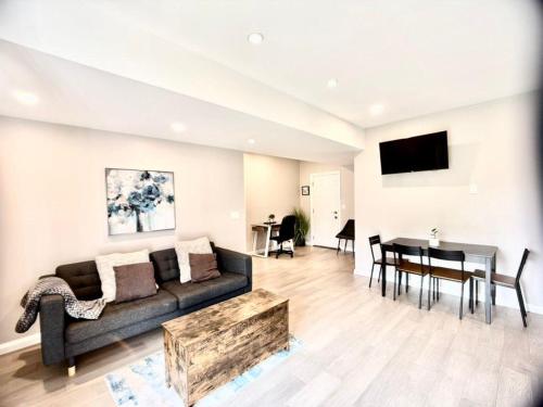 a living room with a couch and a table at The Simple Escape, Walkout Basement on Ravine in Kitchener