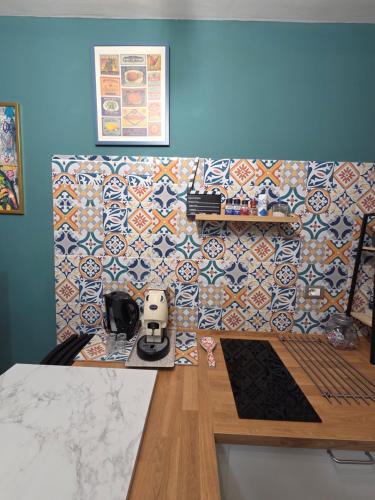 a kitchen with a counter with a tile wall at B&B NewYork, Avellino in Avellino