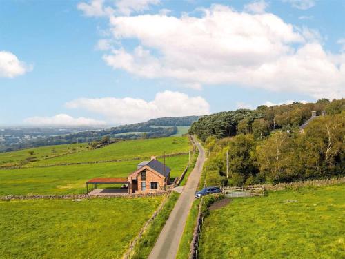a road leading to a house in a field at The Bungalow in Rushton Spencer