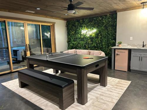 a ping pong table in a living room with a couch at Lux Blue Ridge Cabin, Hot tub, Swing, PingPong! in Mineral Bluff
