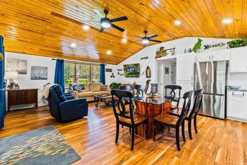a kitchen and living room with a wooden ceiling at Lake Livingston Retreat with Firepit, Fishing, and Game Room in Livingston