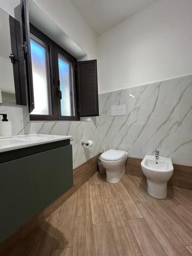 a bathroom with a toilet and a bidet and a sink at Cuore di Agrigento Home in Agrigento
