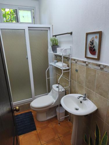 a bathroom with a toilet and a sink at Melany's House's in Ajaxá