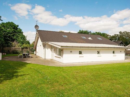 a large white house with a grass yard at 12 person holiday home in Egå-By Traum in Åstrup