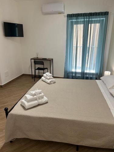 a bedroom with a bed with two towels on it at Cuore di Agrigento Home in Agrigento