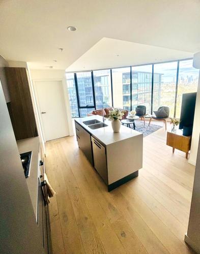 an open kitchen and living room in a building at WiiHost Cosy Retreat! in Melbourne