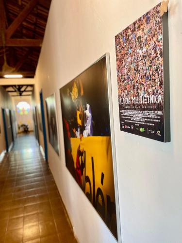 a hallway with pictures on the walls of a building at Hospedaria São Jorge in Sao Jorge