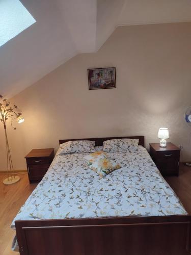a large bed in a bedroom with two night stands at DOBA - Центр 1 кім 5 міс Завжди тепла ! in Mukacheve