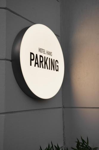 a sign that reads hotel has parking hanging on a wall at Hotel Hans in Copenhagen