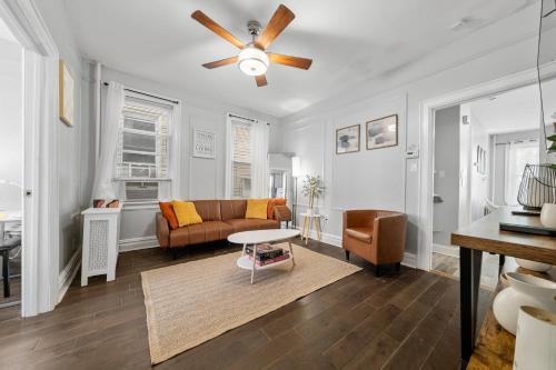 a living room with a couch and a ceiling fan at "Charming Apartment - Just 35 min to Manhattan" in Jersey City