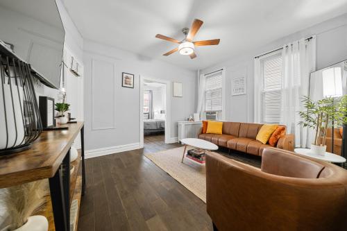 a living room with a couch and a ceiling fan at "Charming Apartment - Just 35 min to Manhattan" in Jersey City