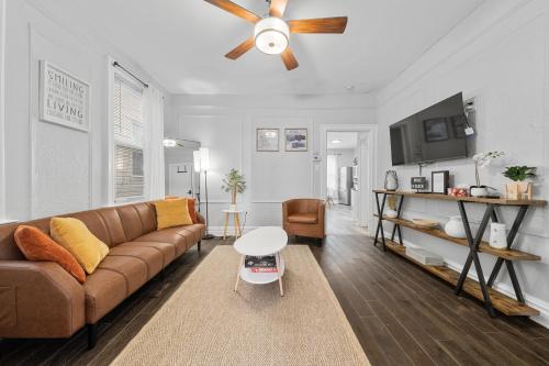 a living room with a couch and a ceiling fan at "Charming Apartment - Just 35 min to Manhattan" in Jersey City