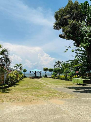 a park with a view of the ocean in the distance at Bulls residence seaview in Toledo City