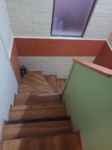 a staircase with wooden floors and a window at Ksa Florida moonlight in La Serena