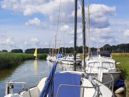a group of boats are docked in a river at Elm Loft in Upton