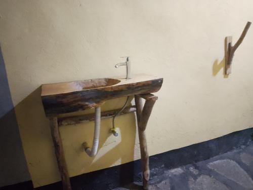 an old wooden sink in a room with a sink at Jungle Lodge Kibale in Kamwenge