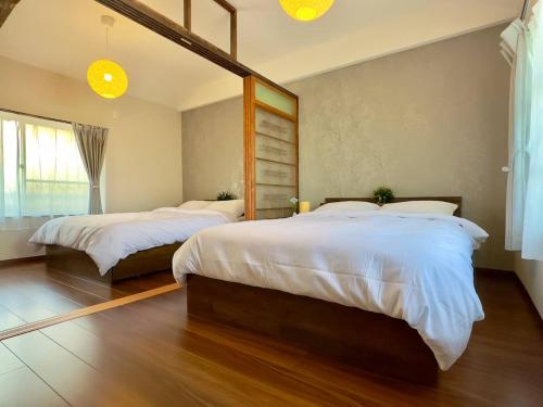 a bedroom with two beds and a large mirror at 20 mins to KIX Izumisano Sta in Izumi-Sano