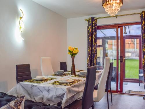 a dining room with a table and chairs at West Park House in Penwortham