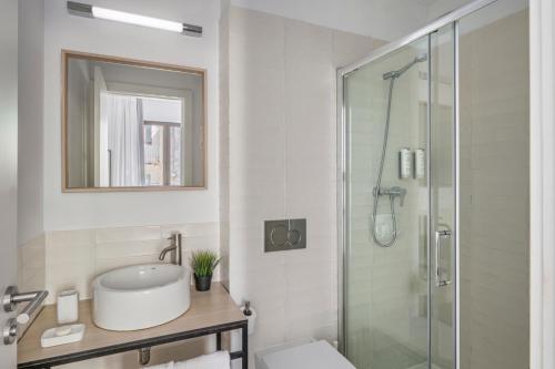 a bathroom with a toilet and a glass shower at Aspasios Poble Nou Apartments in Barcelona