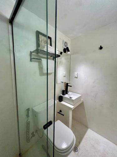 a bathroom with a toilet and a glass shower at Diseño y terraza en Punta del Este in Punta del Este