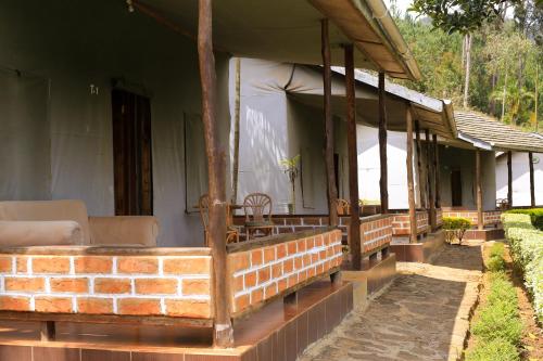 a porch of a house with a brick at LUSHOTO EXECUTIVE LODGE in Lushoto