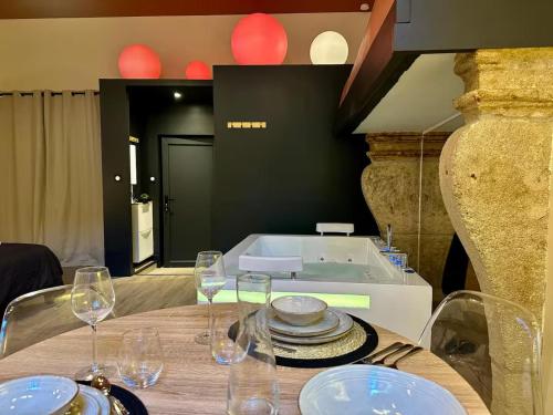 a table with glasses and plates on top of it at Secret Room in Le Puy en Velay