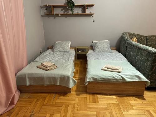 a room with two twin beds and a couch at Pokoje do wynajęcia - Podwisłocze 8a in Rzeszów