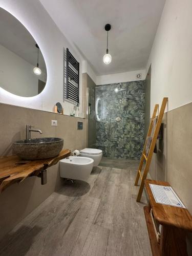 a bathroom with a sink and a toilet and a mirror at Ca' le Stelle in Valmaggiore