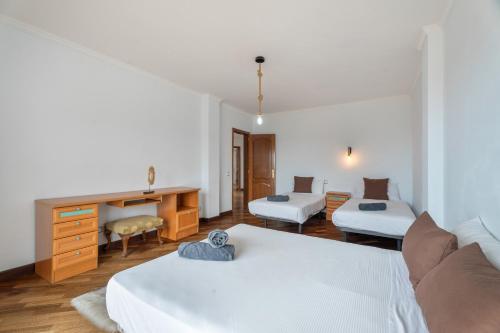 a hotel room with two beds and a desk at Villa Luxury el Mirador in Adeje