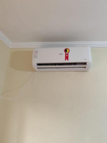 a white appliance sitting on top of a white wall at Pousada São Miguel Arcanjo in Aparecida