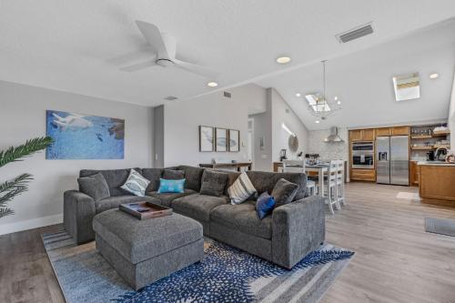 a living room with two couches and a kitchen at Sea-Esta in Siesta Key