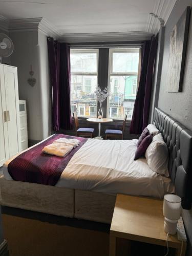 a bedroom with a large bed and a window at The Hotel Blackpool in Blackpool