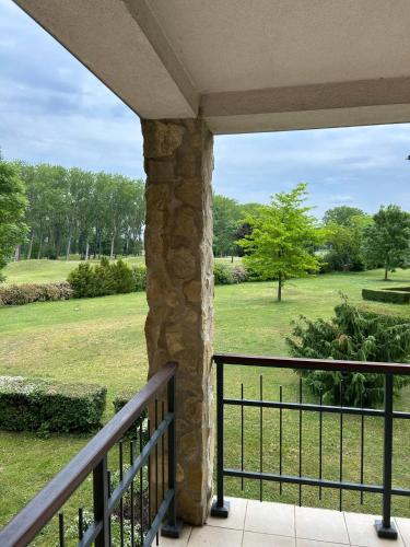 a balcony with a view of a park at Büki Villa Park Apartman in Bük