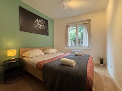 a bedroom with a bed with two towels on it at Cosy F2 , Marx Dormoy A WIFI in Clermont-Ferrand