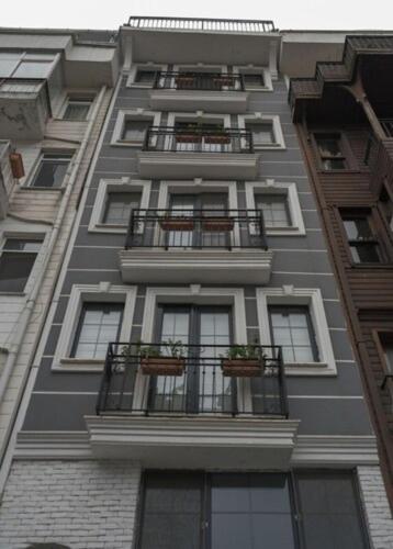 a tall building with balconies and plants on it at Vico hotel in Istanbul