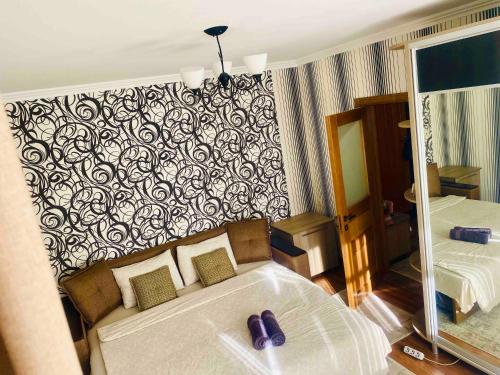 a hotel room with a bed and a mirror at Air-Moldova 25 in Chişinău