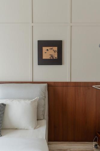 a bedroom with a bed and a picture on the wall at The M Medini Macrolink by Cactus Homestay in Iskandar Puteri