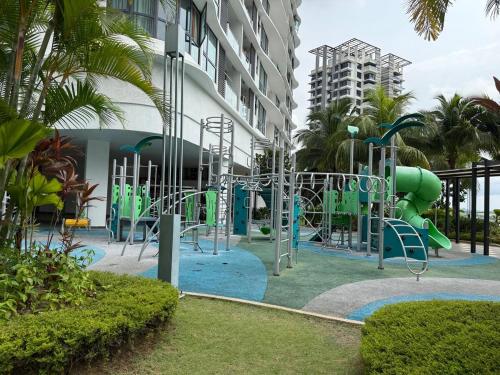 a playground in front of a building at The M Medini Macrolink by Cactus Homestay in Iskandar Puteri