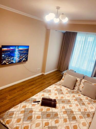 a living room with a couch and a tv on the wall at AIRPORT-TAXI-PARKING-Card in Chişinău