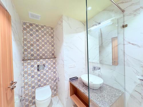a bathroom with a toilet and a glass shower at Sea Beach Hotel Room with Balconies, Restaurant, Parking & Free Wi-Fi ,Beach Front Location - Fully Air Condition with All Luxury Luxuary Rooms, A Top Rated Hotel In Puri in Puri
