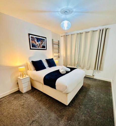 a bedroom with a large bed and a window at Harbour Horizons in Edinburgh
