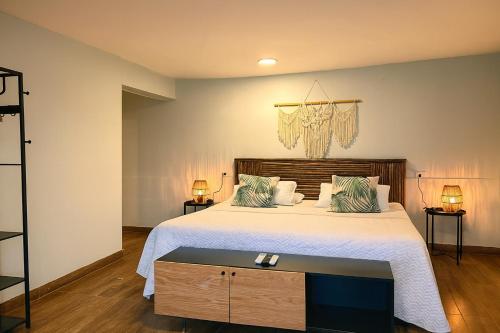 a bedroom with a large bed and a chandelier at Fragata Island House in Isla Grande