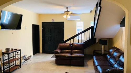 a living room with a couch and a tv at Rocky Point Casa Mango w Pool Walk to Beach in Ciudad Constitución