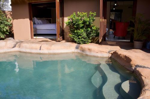 a large pool of water in front of a house at Elroiairbnb in Amanzimtoti