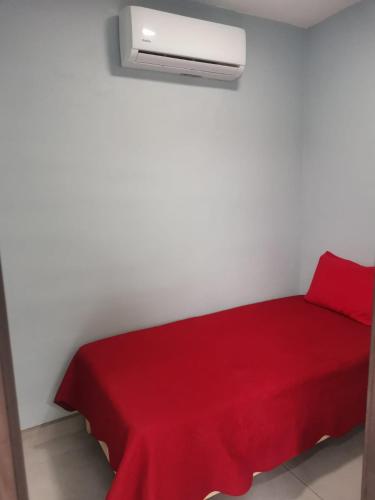 a room with a red bed with a red blanket at Rocky Point Casa Mango w Pool Walk to Beach in Ciudad Constitución