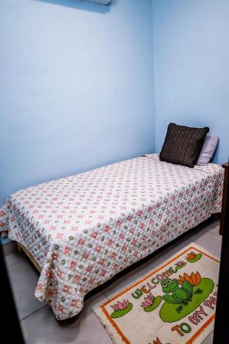 a bed in a room with two rugs on the floor at Rocky Point Casa Mango w Pool Walk to Beach in Ciudad Constitución