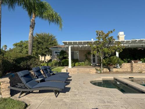 a group of chairs sitting next to a swimming pool at Temecula Wine Country Villa in Temecula