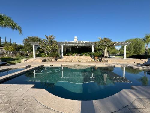 a swimming pool in a courtyard with a building at Temecula Wine Country Villa in Temecula