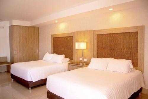 Postel nebo postele na pokoji v ubytování Hotel Campestre las Camelias