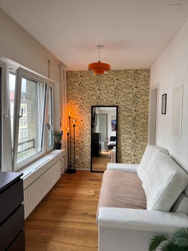 a bedroom with a bed and a brick wall at Zentrales Apartment St Gallen in St. Gallen
